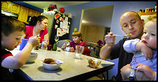 Fairfax residents Christine and George Lively, pictured here with their children, Carl, 4, Georgia Mae, 8, and Lance, 21 months, say they have people over more often for dinner than they are invited to others' homes.